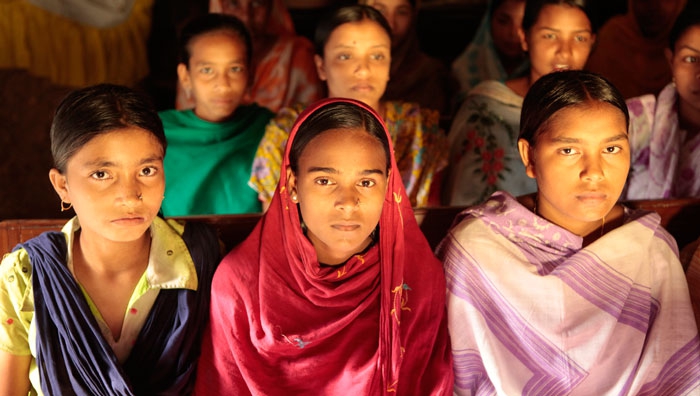 A group of young Bangladeshi girls sit together