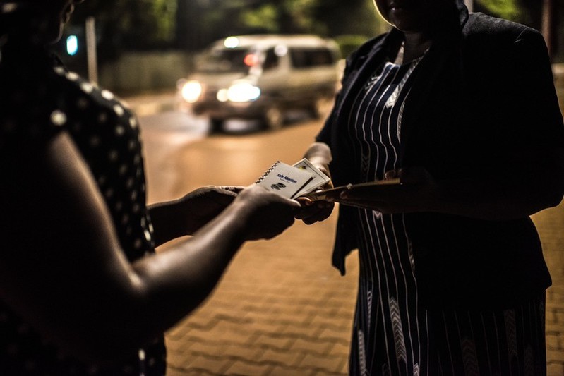 Deborah, a sex worker and beneficiary of the Lady Mermaid’s Bureau project, receives a booklet on safe abortion from LMB project officer Noor in central Kampala.