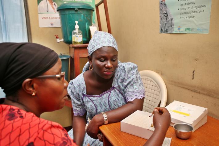 Health worker explaining the pill to a client