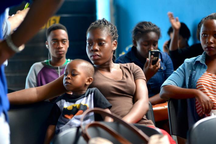  21-year old Jenny Marcelino* and her three-year old son wait for free counselling, tests and treatment at the Amodefa clinic in Maputo. 