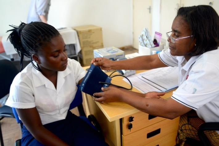 Nurse Julia Suzette Mulambo* gives family planning counselling and treatment to 16-year old student Eleria Horacio Mabucule, at the Amodefa clinic in Boane, in southern Mozambique.