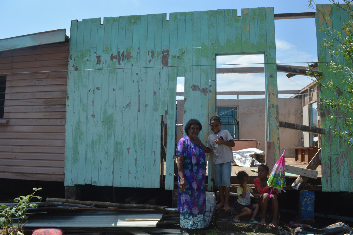 Jokaveti in front of her destroyed house