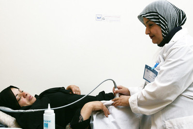 staff performing check up on woman