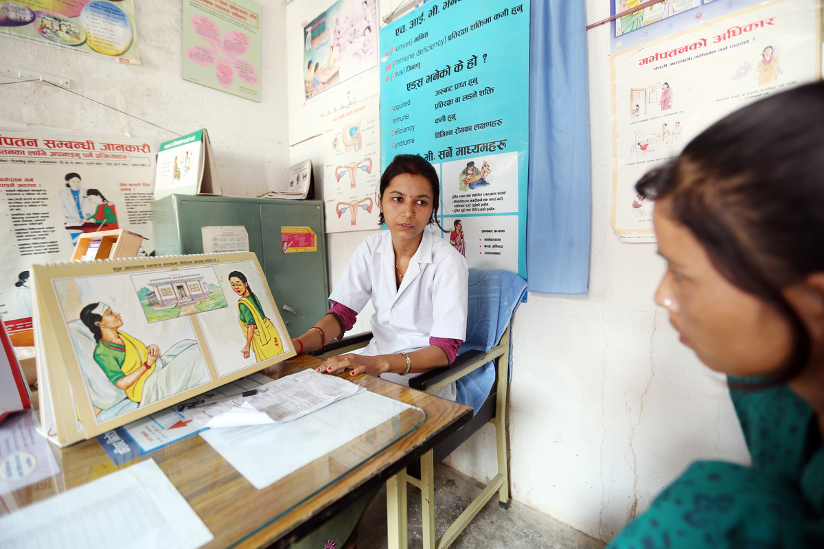 IPPF clinician and female client in Nepal getting sexual health services