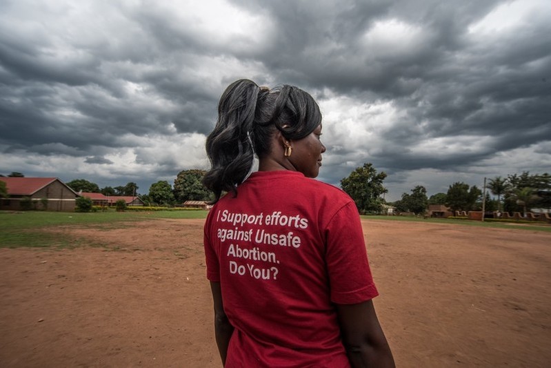 Milly, a teacher and VODA community volunteer, wears a t-shirt advocating for safe abortions in Kasawo, Uganda.