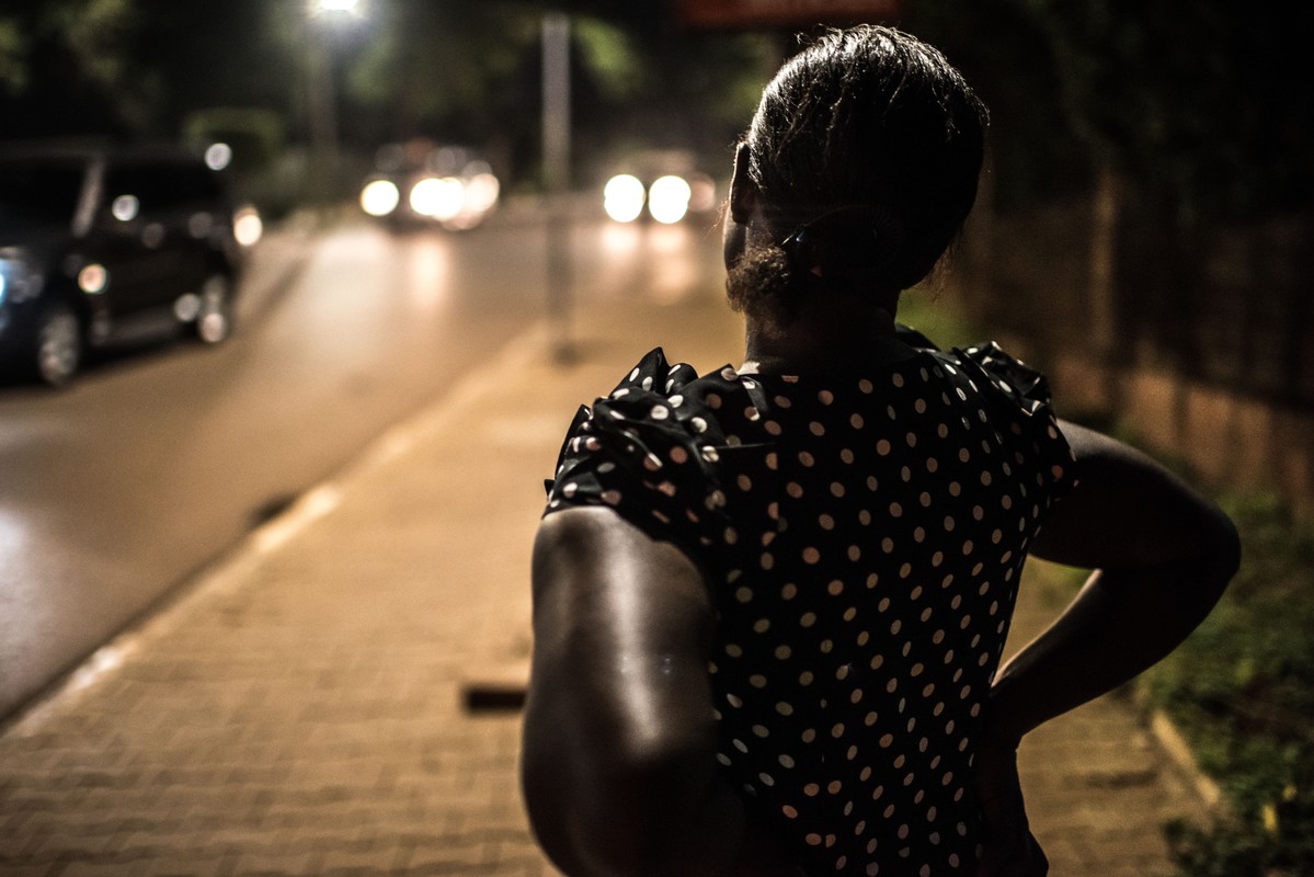 Deborah, a sex worker and beneficiary of the Lady Mermaid's Bureau project, at night in central Kampala.