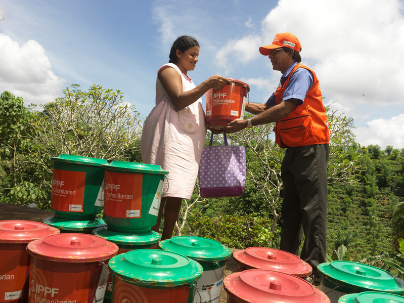 Woman receiving dignity kit. 