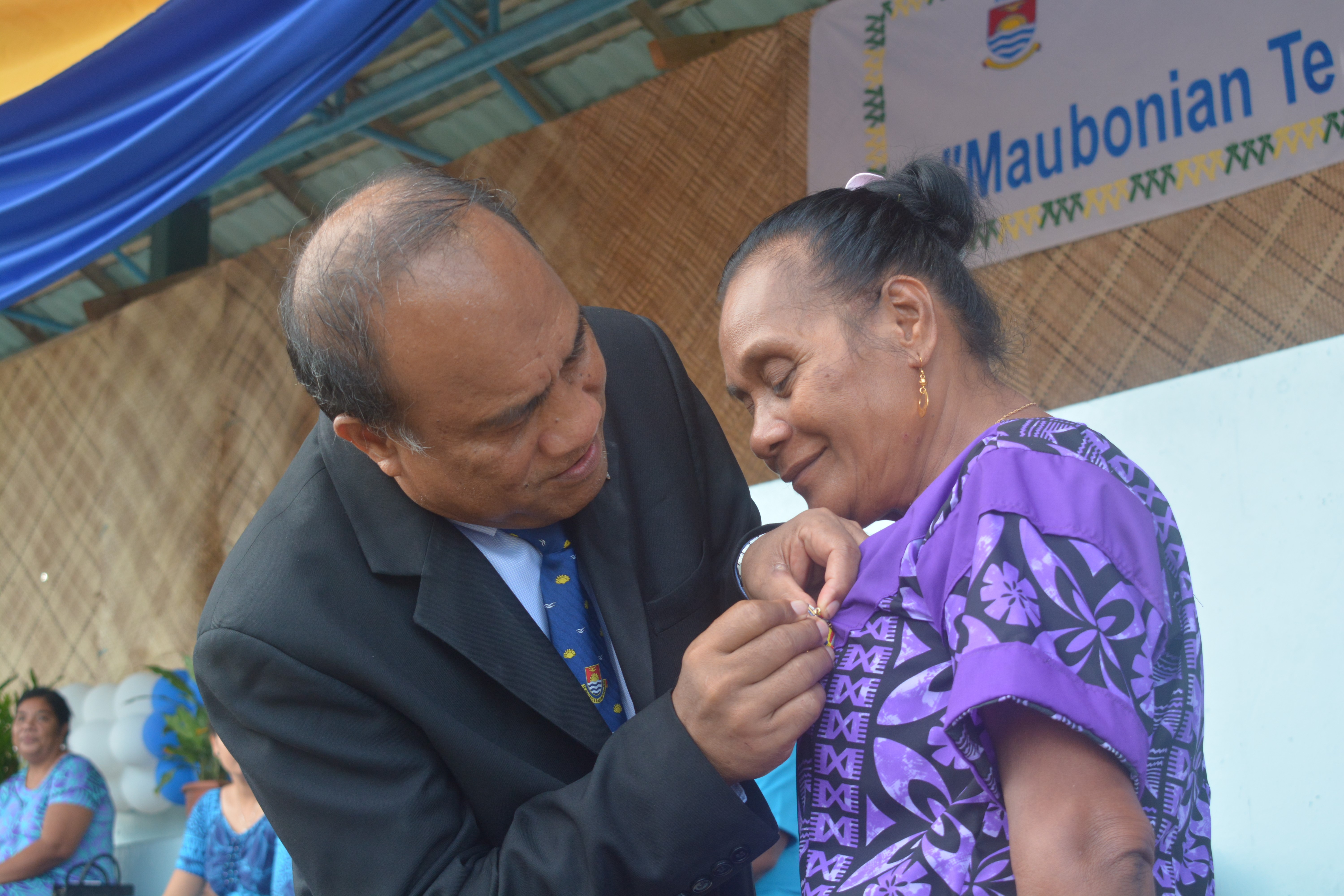 Norma Yeeting receiving her award from President Taneti Mamau