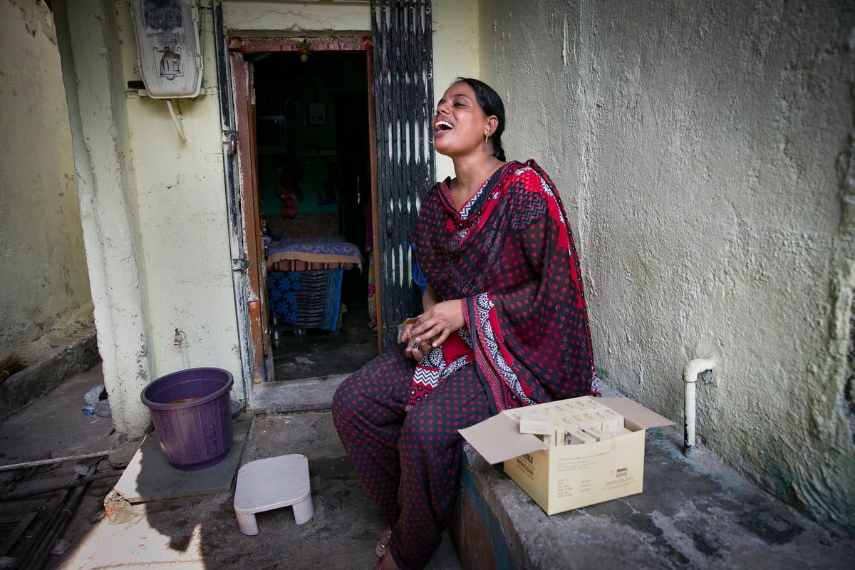 Hasina, a sex worker and peer educator sits outside a brothel, India