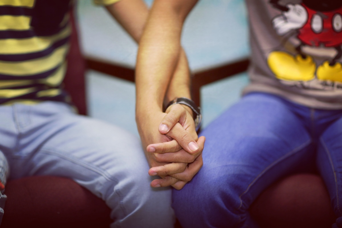 Two people holding hands