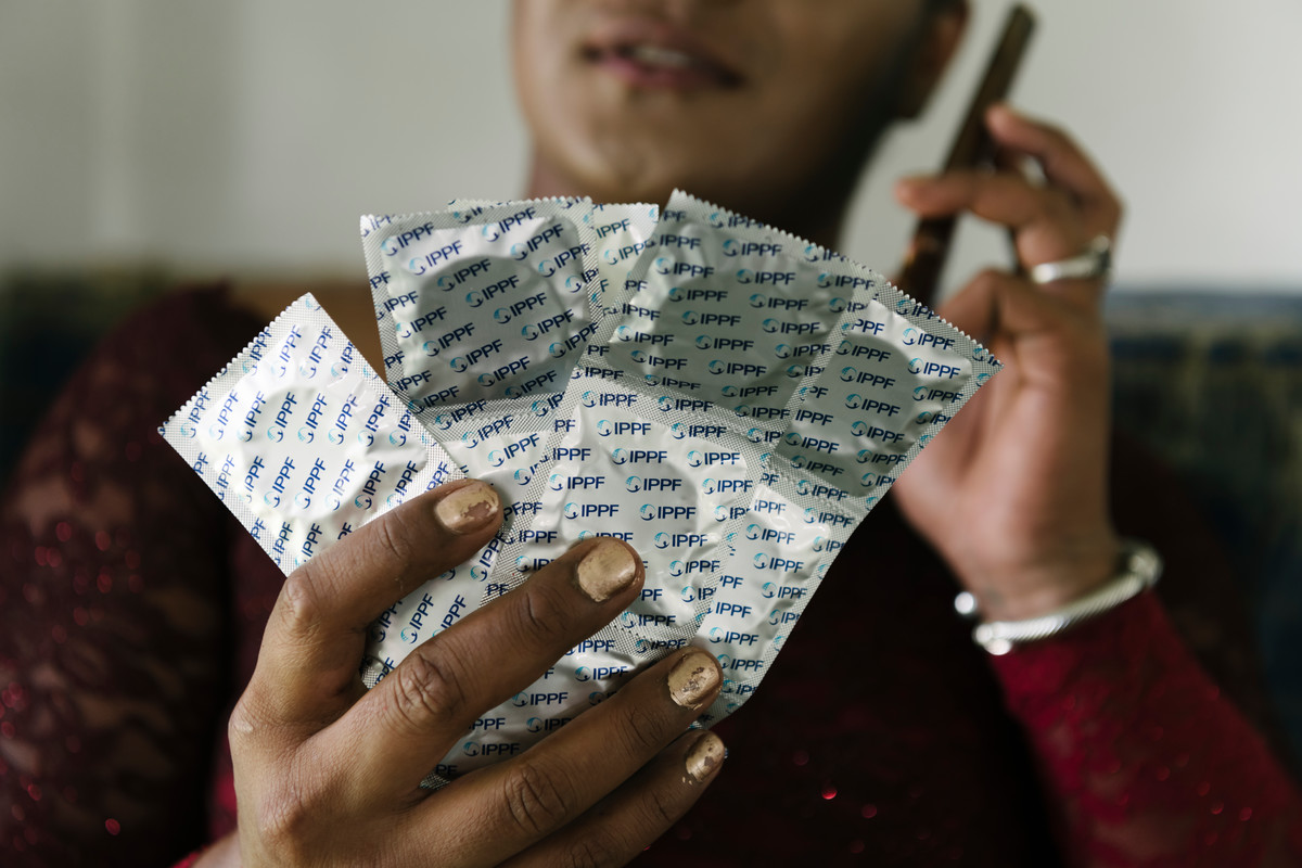 Leilani from Tonga holds up a pile of condoms