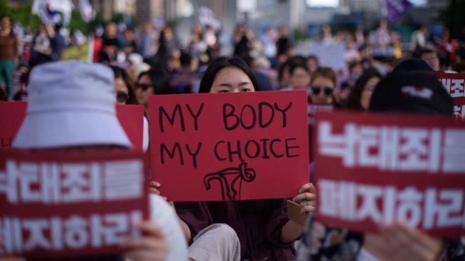 woman holds sign in South Korea 'my body, my choice'