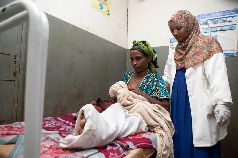 Midwife Rewda Kedir examines a newborn baby and mother in a health center outside of Jimma, Ethiopia