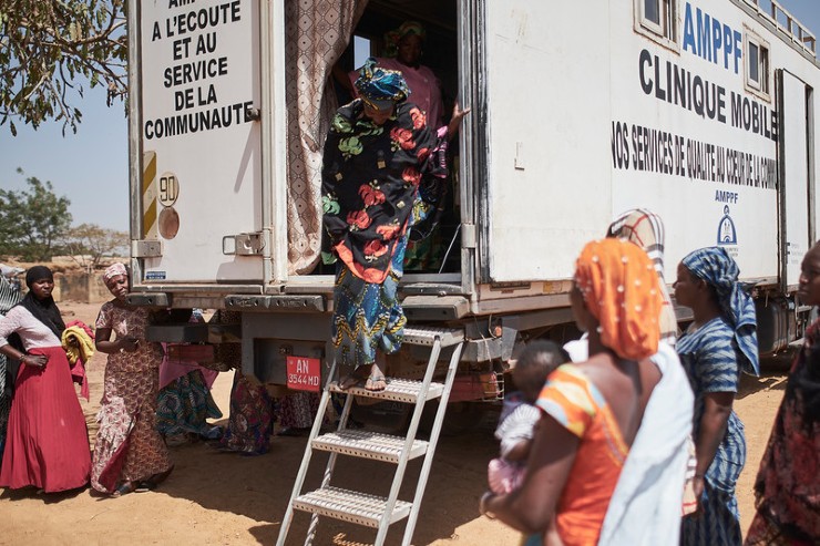 A woman exits the AMPPF mobile clinic