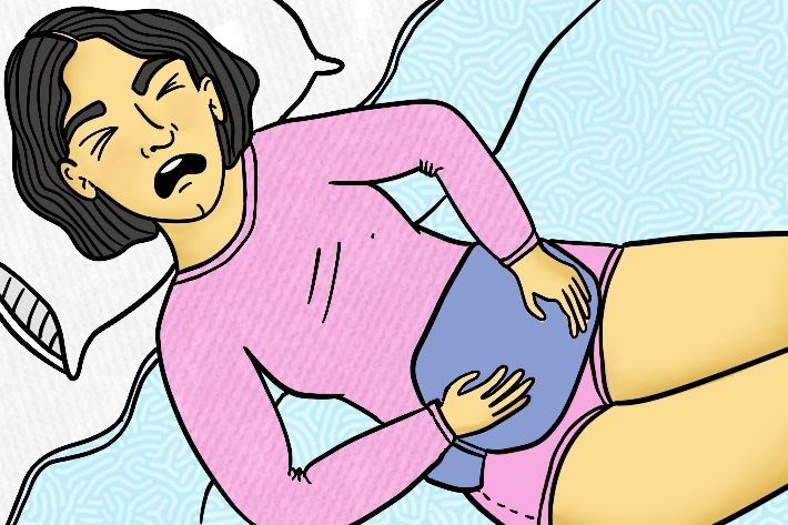 A woman in distress with a hot water bottle over her tummy