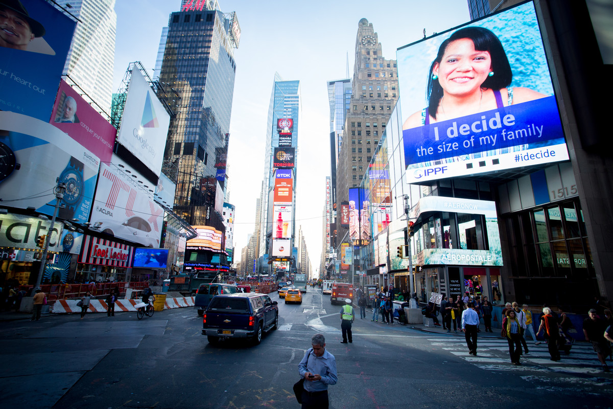 An digital billboard in Times Square reading: "I decide the size of my family"