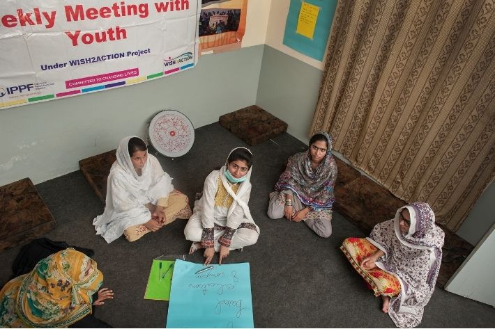 A group of young women gather to discuss sexual and reproductive health