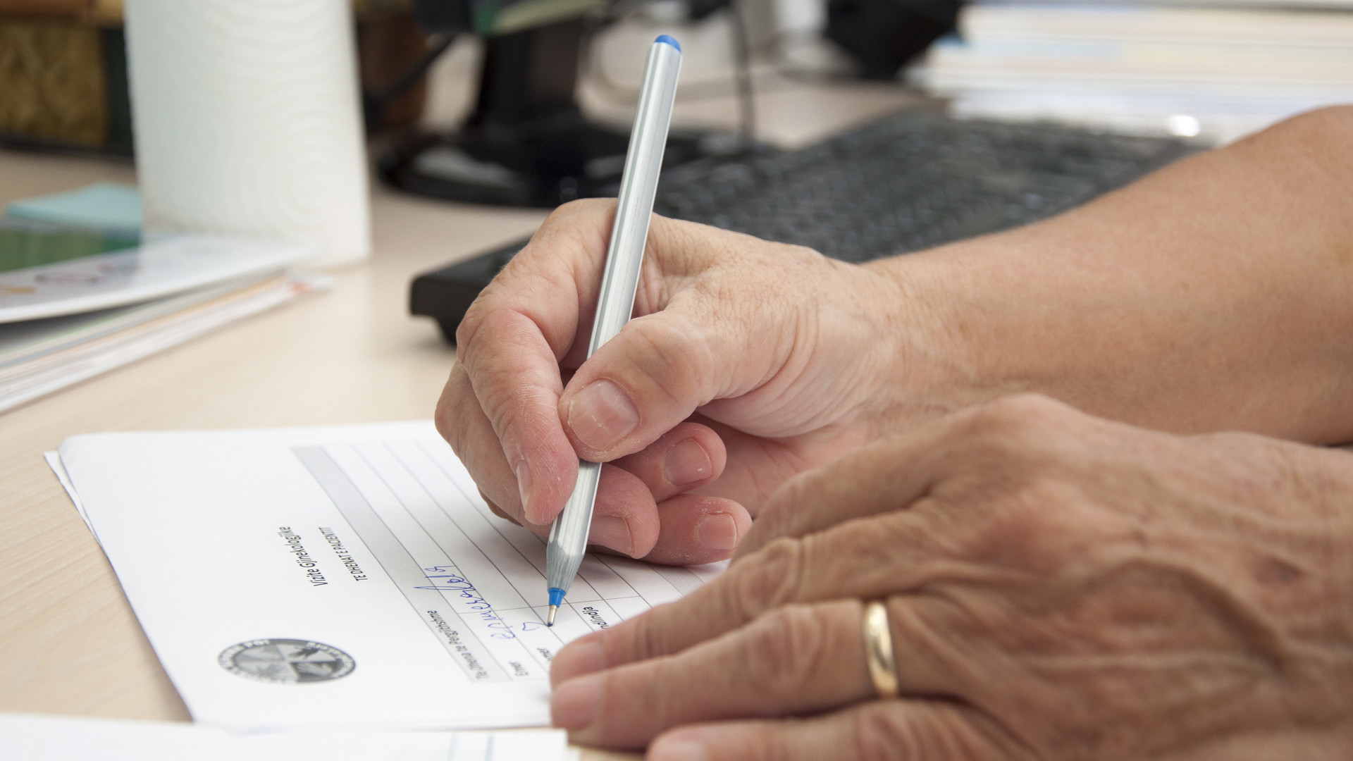 Healthcare worker writing records. 