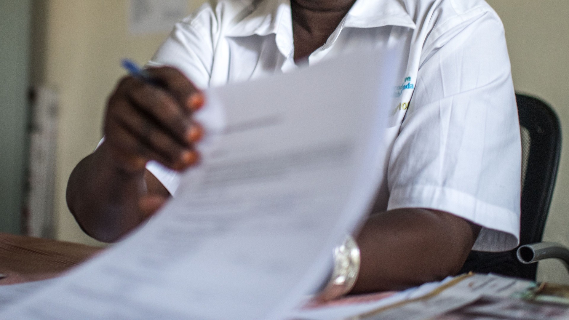 Healthcare worker writing records. 