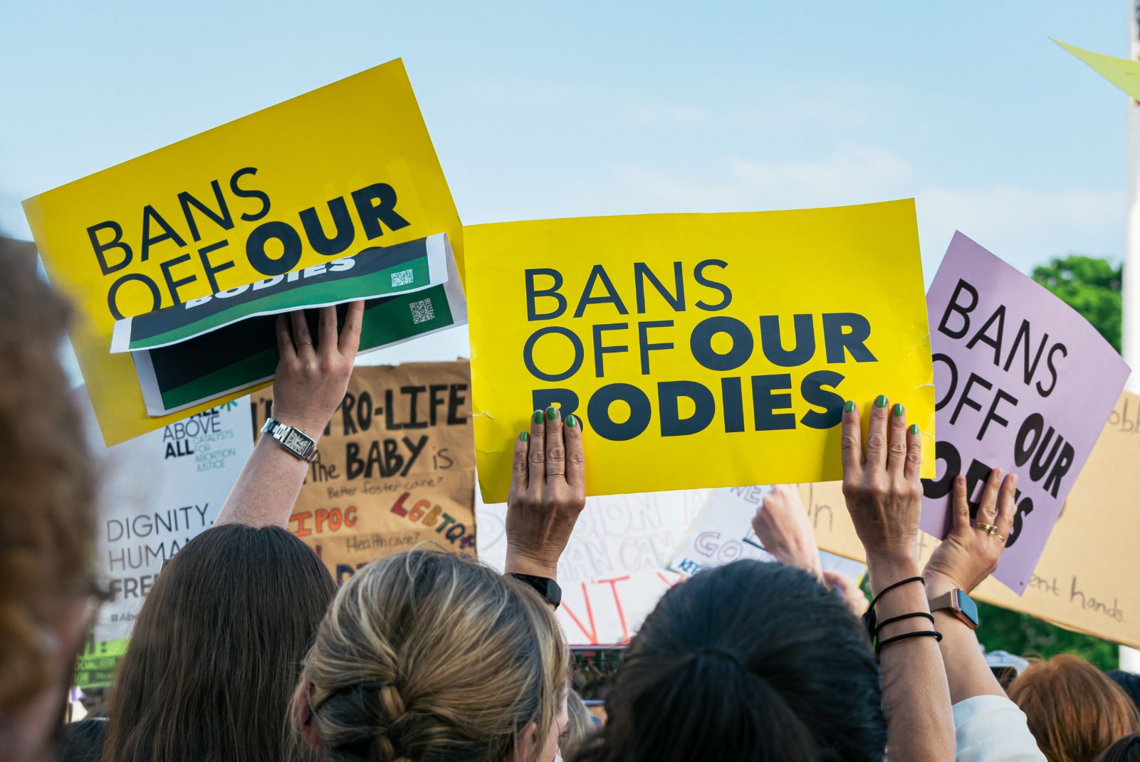 Protest sign reads "bans off our bodies"
