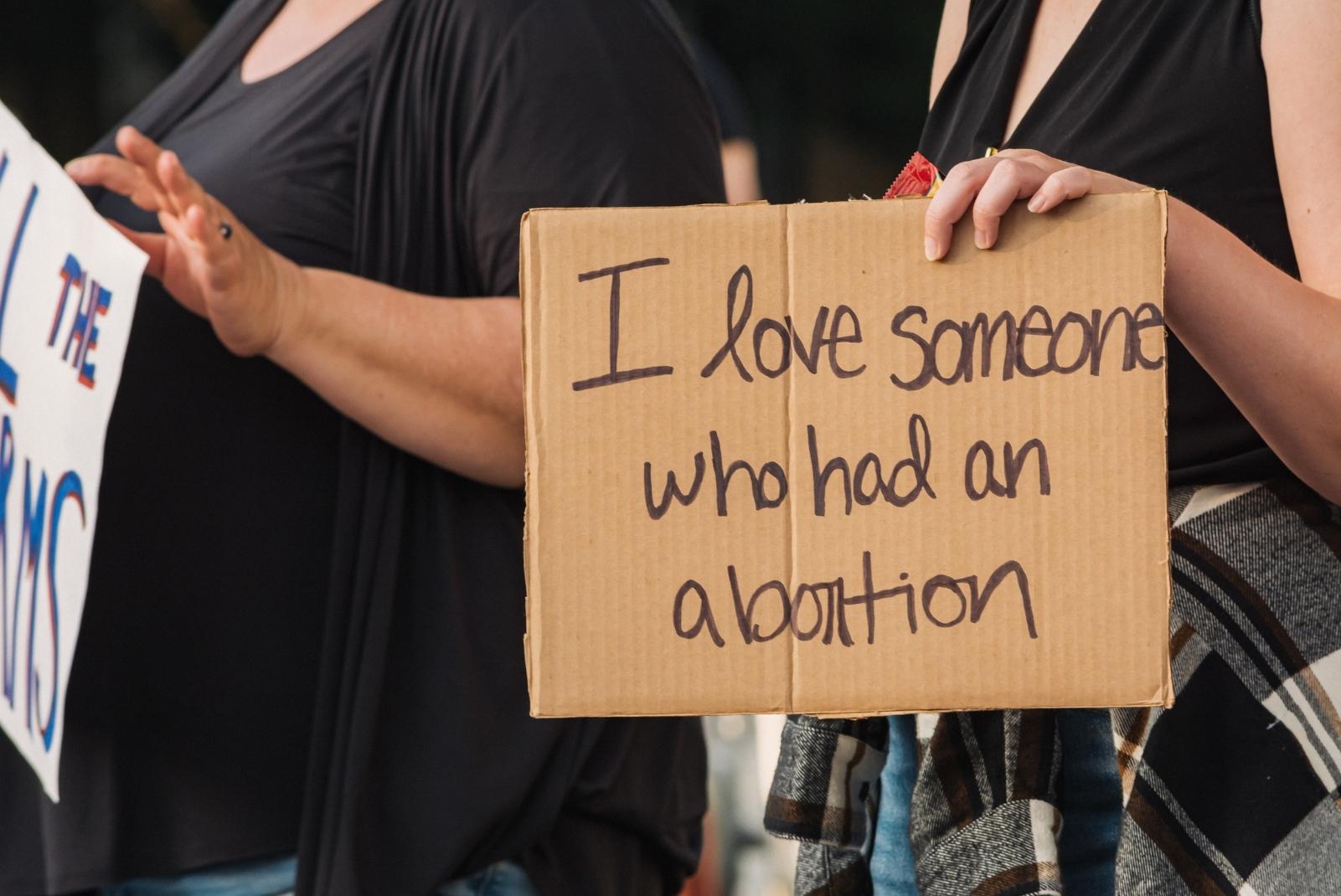 Protest sign reads "I love someone who had an abortion"