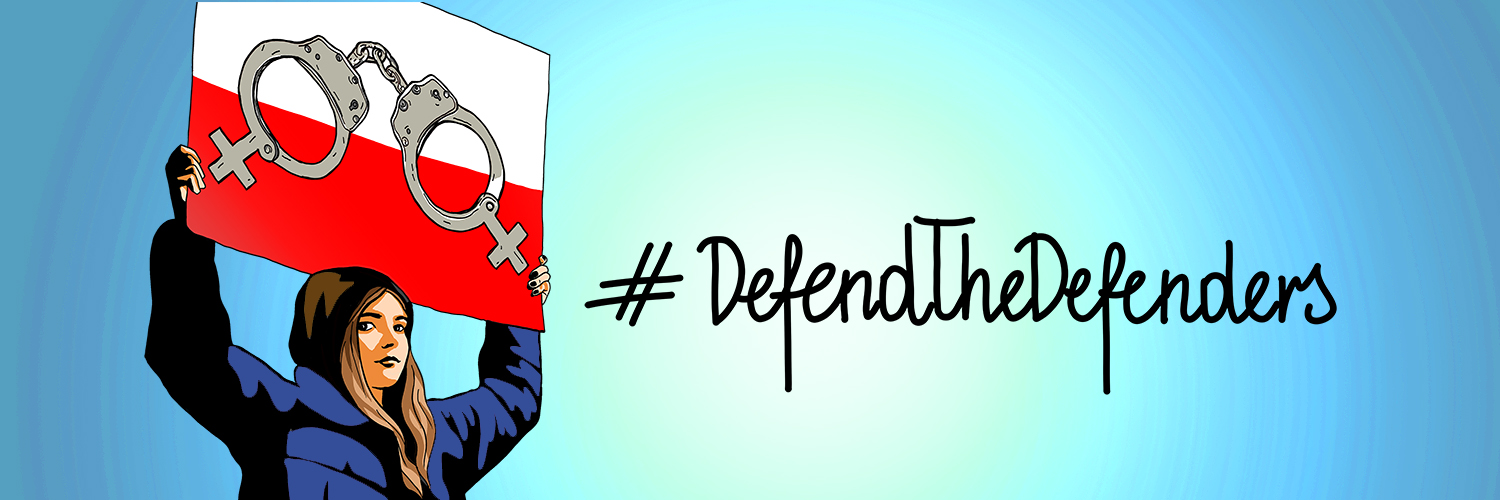 woman holding a sign saying defend the defenders 