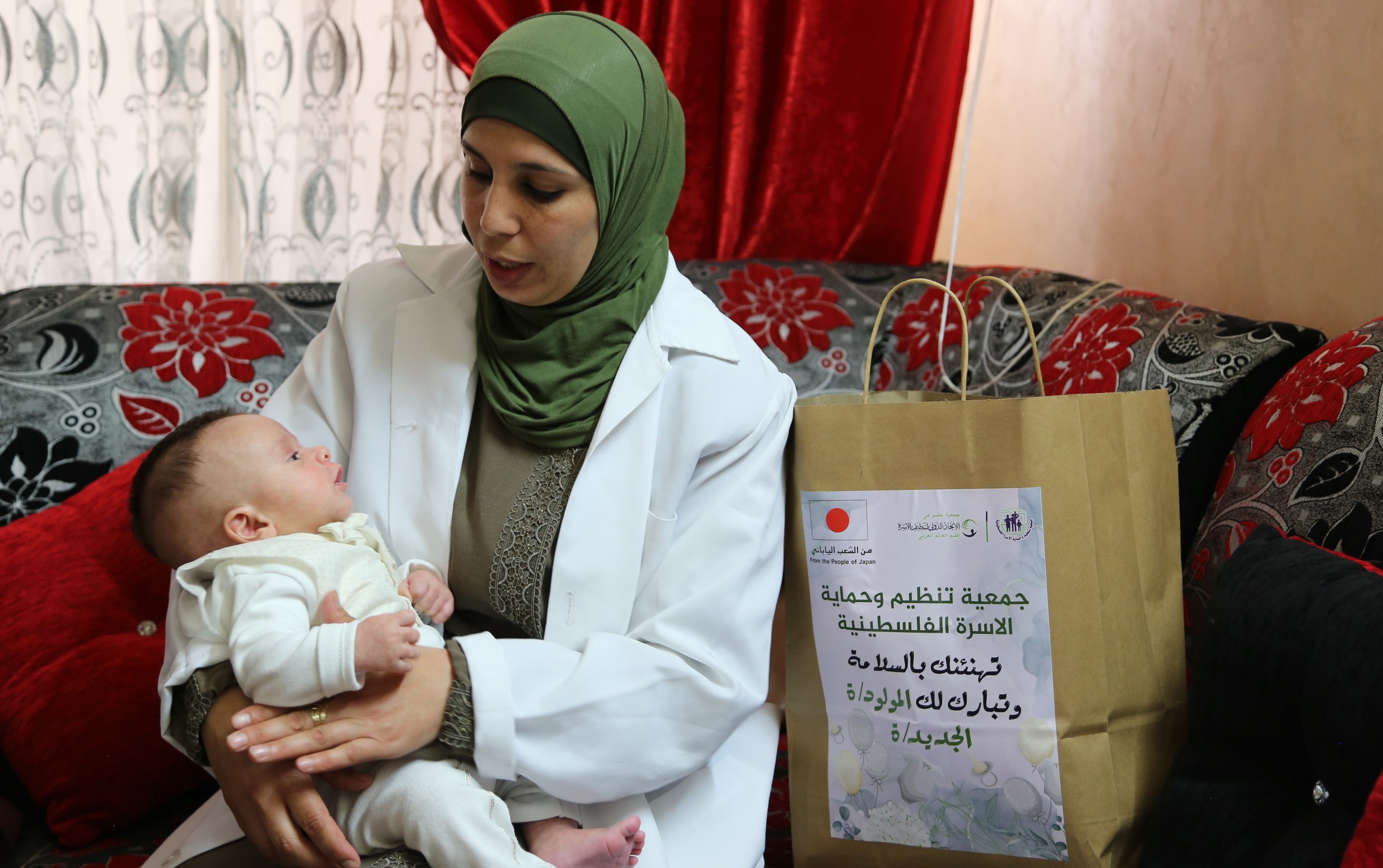 mother and baby receive goods in Palestine