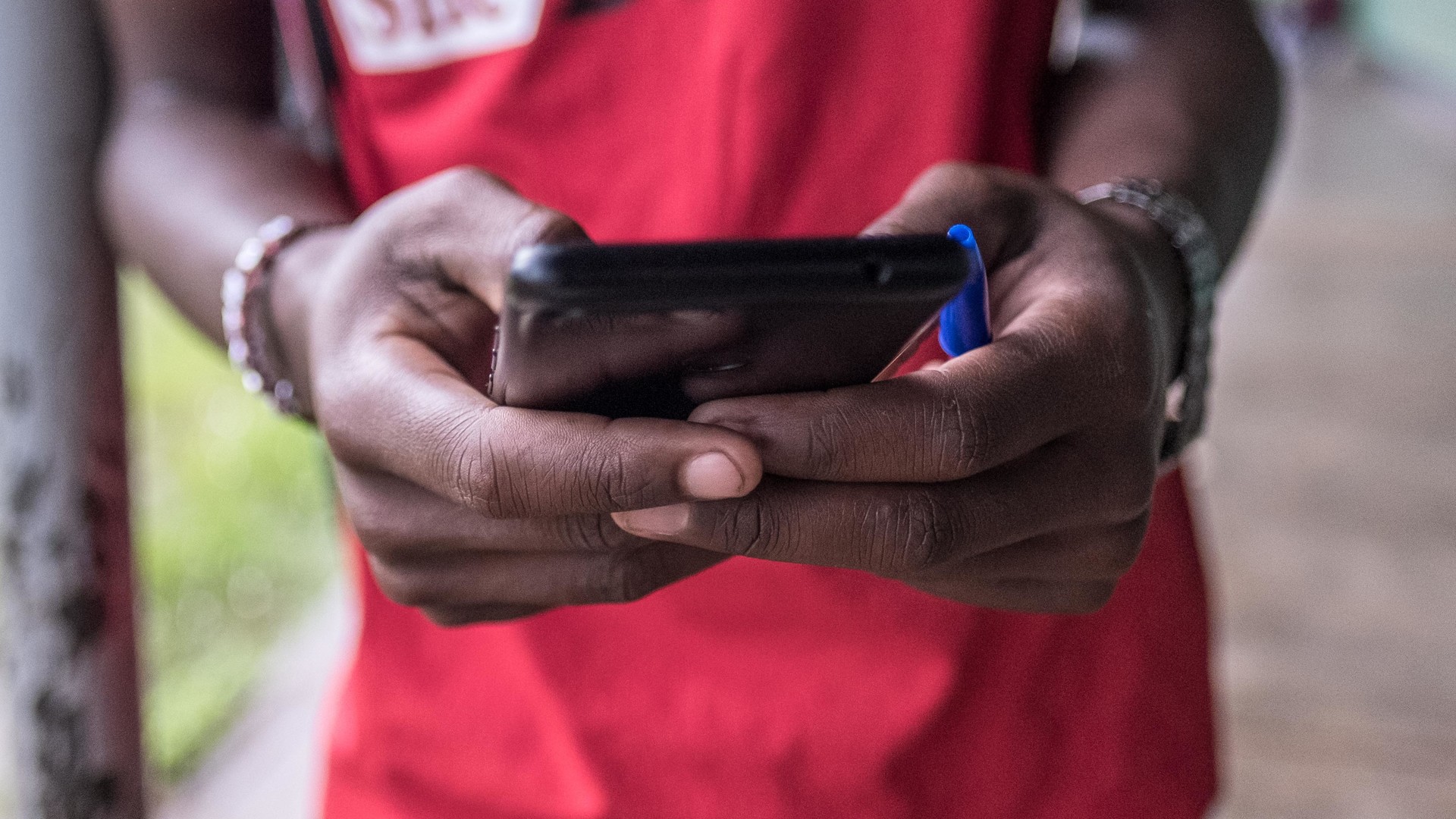 Image of a person's hands using a mobile phone