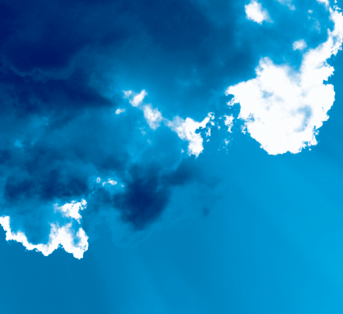 A blue sky with dark blue and white clouds