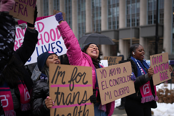 People's March 2025 protesters with signs supporting SRHR