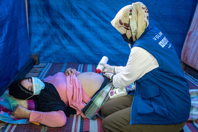 Humanitarian healthcare worker with a client