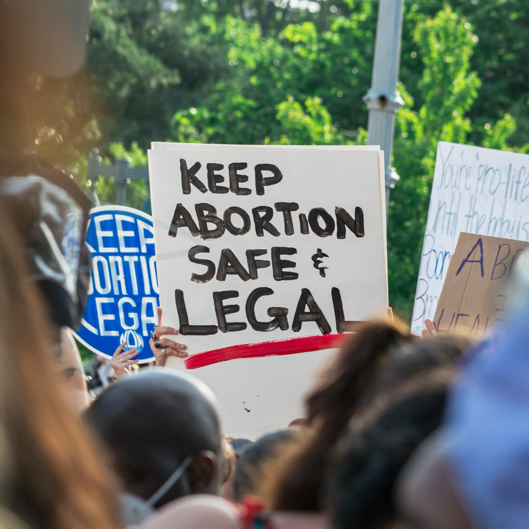 Protestor holds sign saying Keep abortion safe and legal"