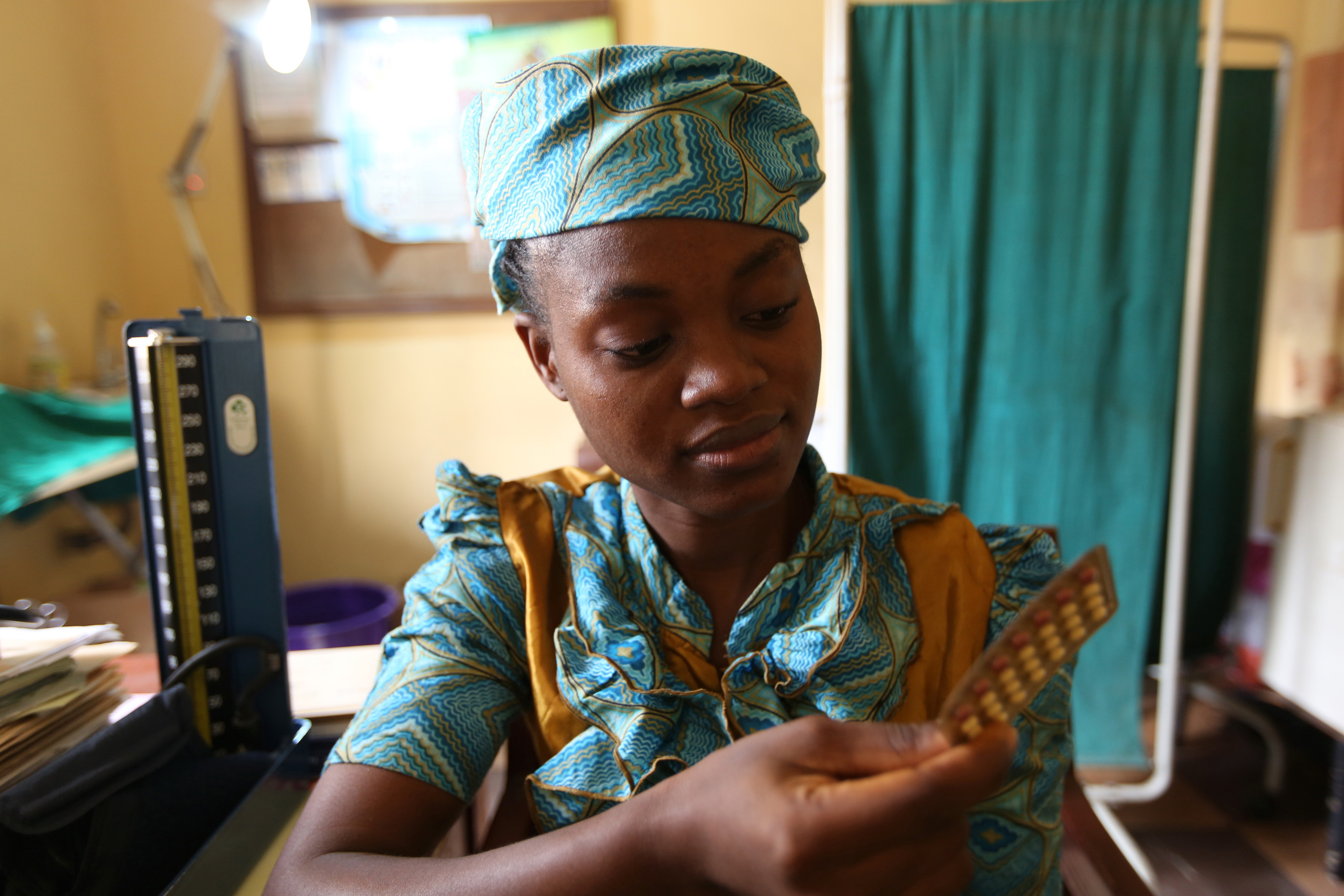 A client holds her contraceptive pills