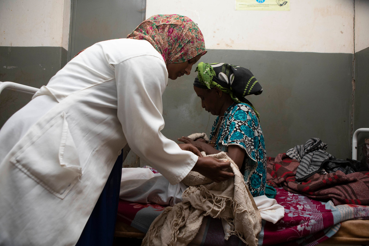 woman sits on a bed with her newborn child - Ethiopa