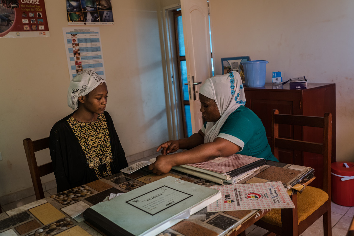 Sherifa, midwife at Mim Ahmadiyya Muslim Hospital, 28 attends to her patient Mariam Mohammed, 23, who safely delivered a baby boy the day before.