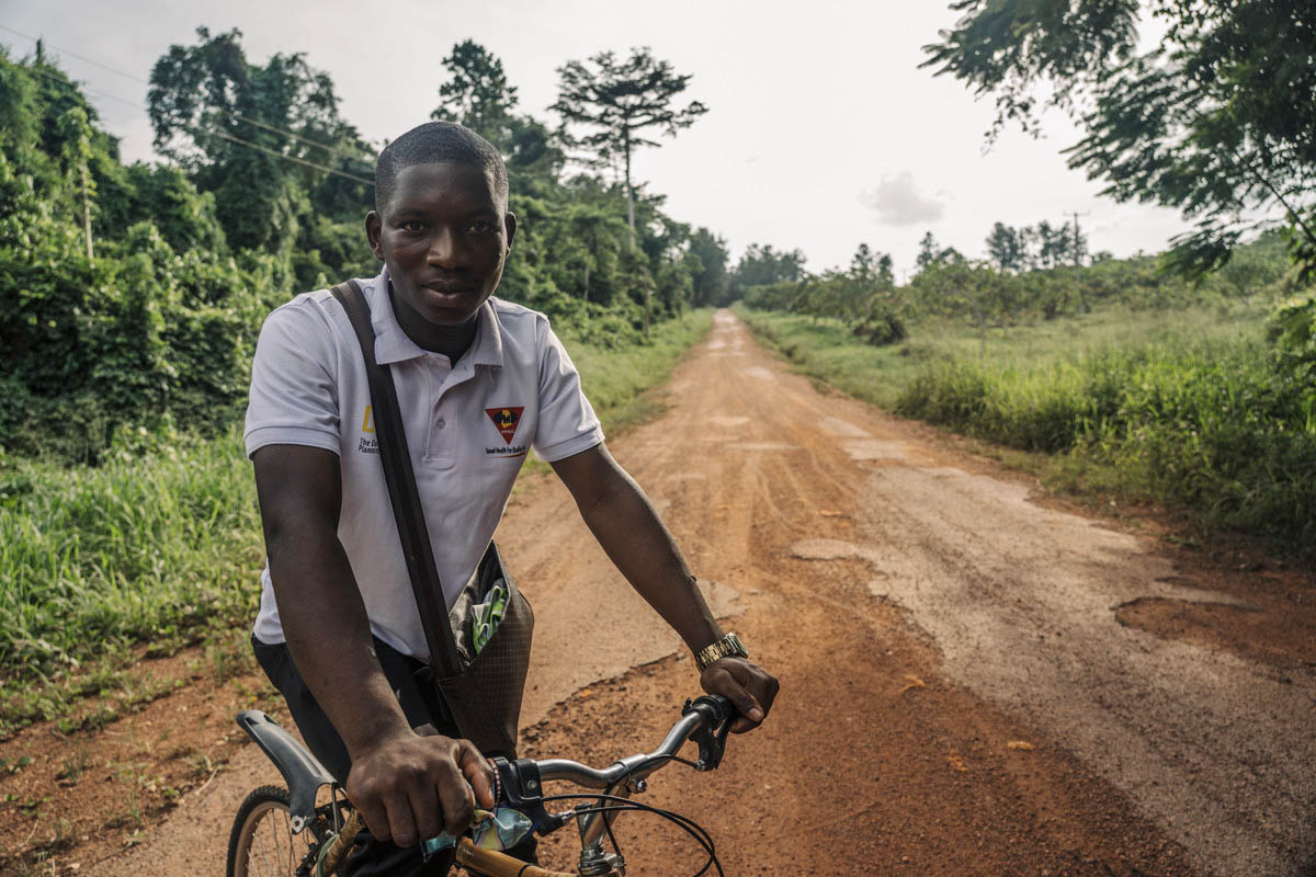 Michael Awuni, 20 peer educator and a student at Ghana Greentech Academy cycles home from school