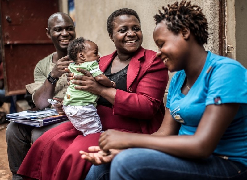 Masitula, a sex-worker and beneficiary of the Little Mermaids Bureau project, with project officers Noor Nakigozo and Ali Kikongo at her home in Kampala, Uganda.
