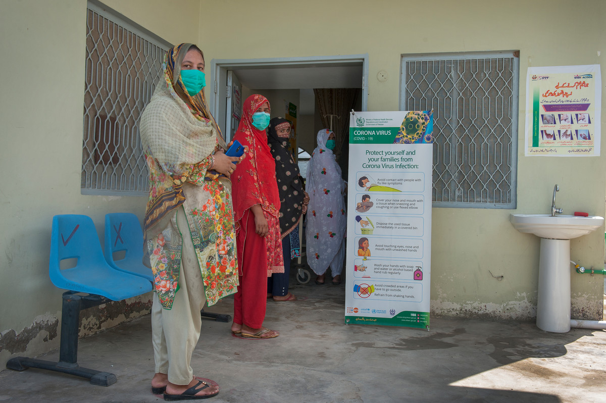 Women wait to be seen at a clinic in Pakistan