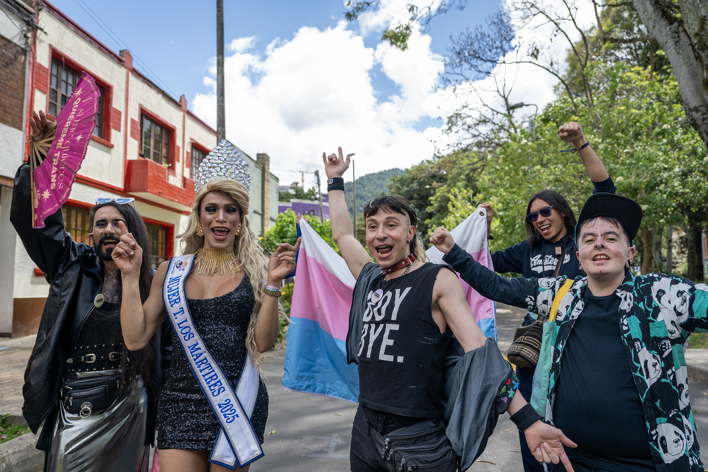members of the trans community walk with pride in a street in Bogota