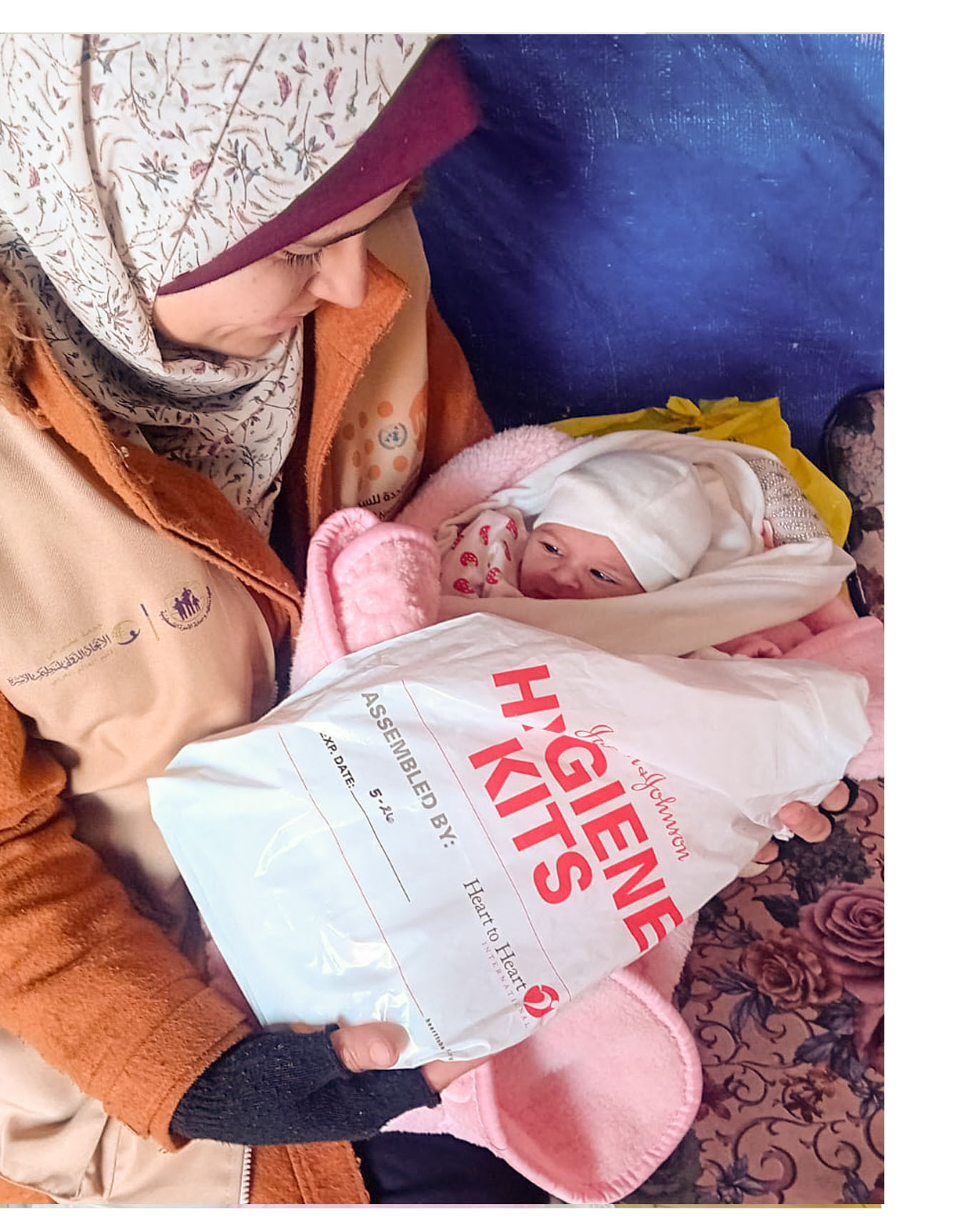 A mother receives a kit from PFPPA in Gaza.