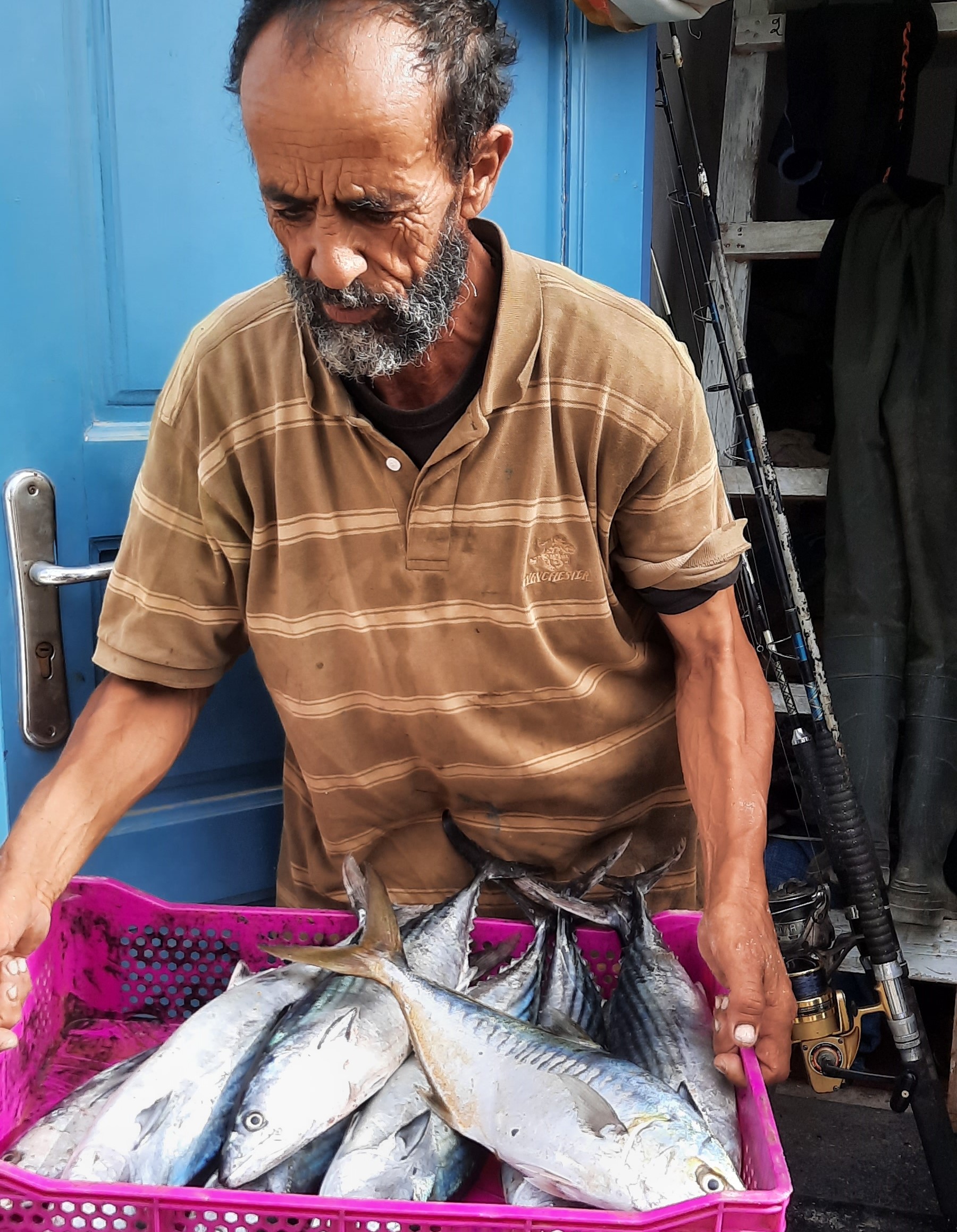 A fisherman carrying the day's catch