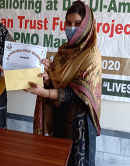 A survivor receiving her training completion certificate