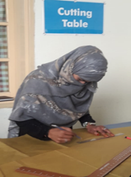 A survivor engaged in cutting session at Government Vocational Centre