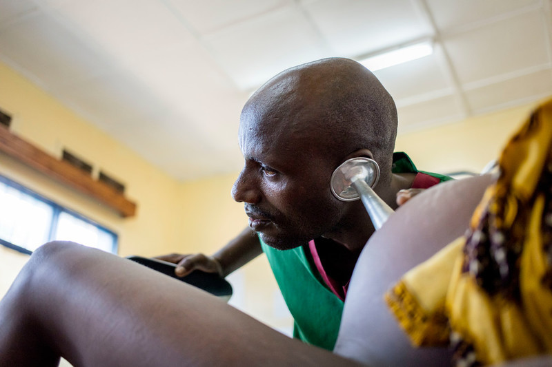 Midwife Desire Manirakiza checks Mshirimana Florence, 22, who is in labour with her first child at ABUBEF clinic in Bujumbura. 