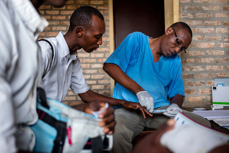 Students are given a finger prick HIV test by staff from the ABUBEF mobile clinic at Municipal Lycee of Nyakabiga school in Bujumbura. 