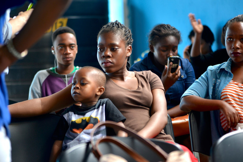  21-year old Jenny Marcelino* and her three-year old son wait for free counselling, tests and treatment at the Amodefa clinic in Maputo. 