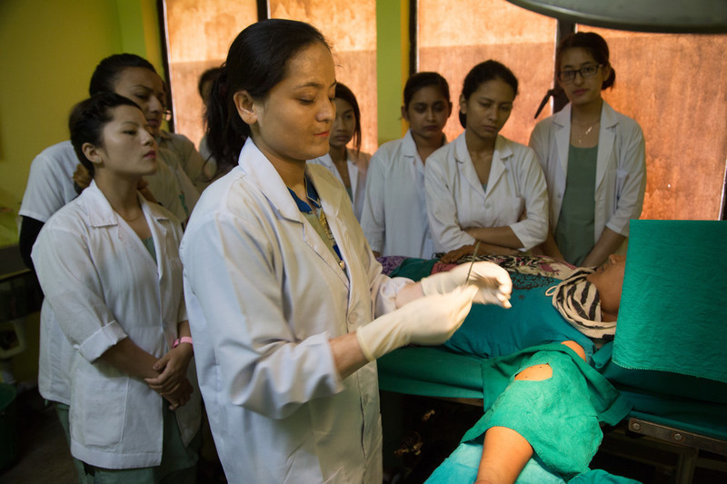 33 year old Ulmila Tamang having contraceptive implant inserted at the FPAN Kathmandu clinic. First year student nurses observe the procedure. 