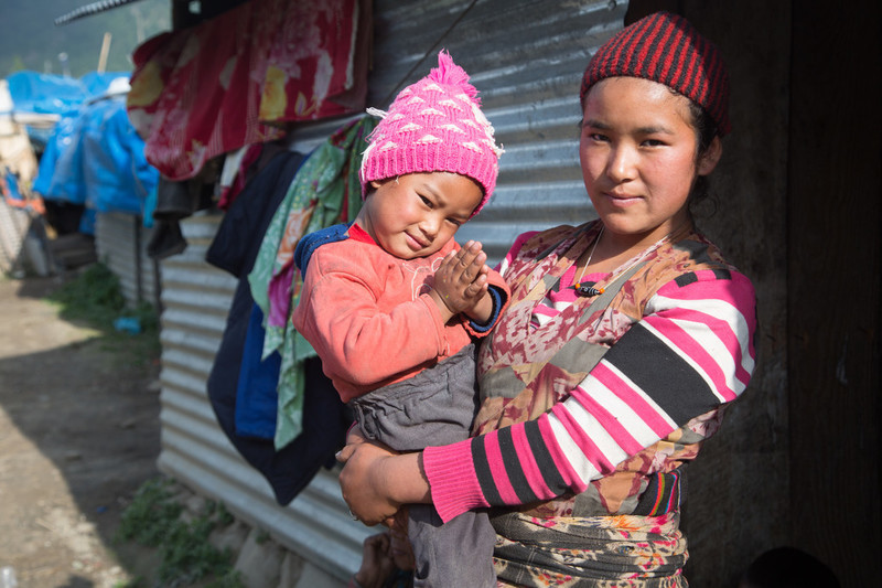 Jomini outside her temporary house in Northern Nepal which she has been living in since the earthquake destroyed her house. She was just sixteen years old when her parents forced her to marry. 