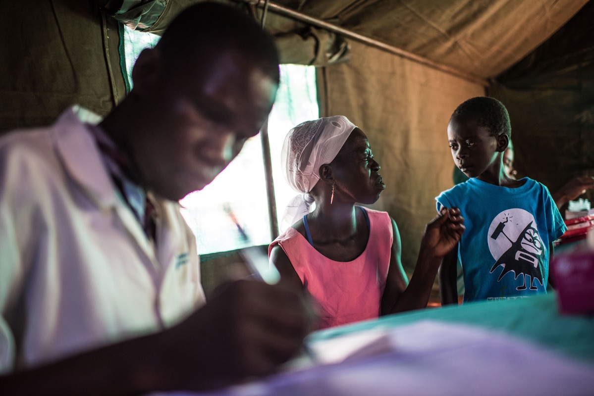 Clinician, Kedi Samuel, sees a woman with abdominal pains. 