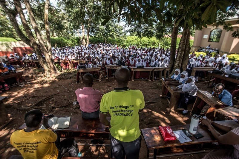 Jonathan from VODA and teacher Peter talk to students at a secondary school in Kasana about pregnancy, STIs and safe abortion.